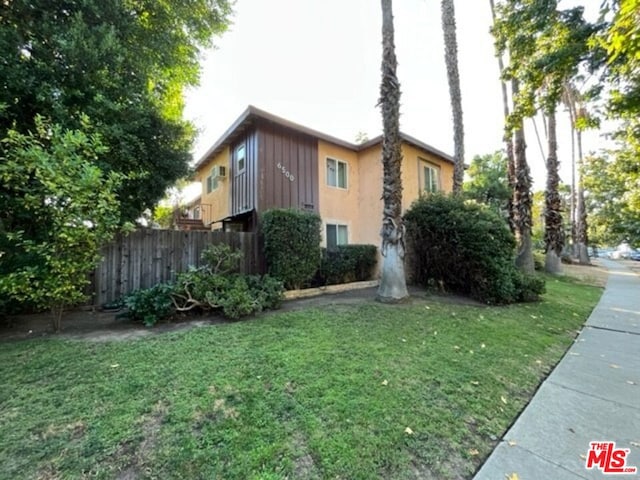 view of side of property featuring a yard