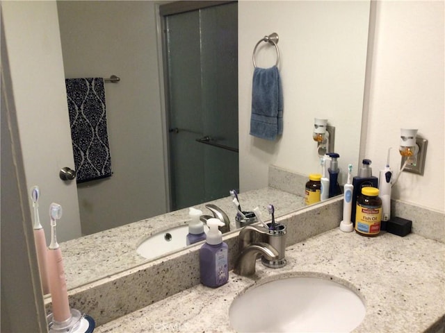 bathroom featuring vanity and a shower with shower door