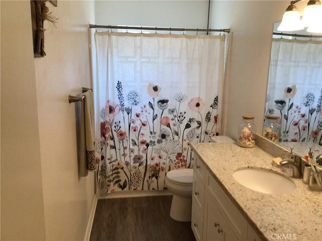 bathroom featuring vanity, hardwood / wood-style floors, and toilet