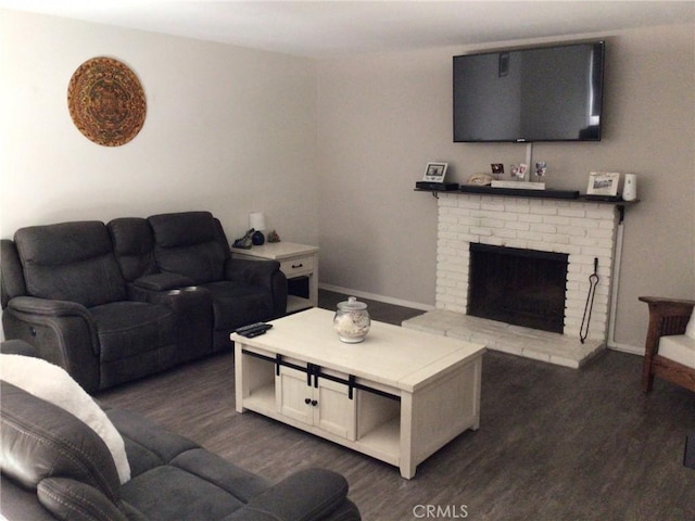 living room featuring a fireplace and dark wood-type flooring