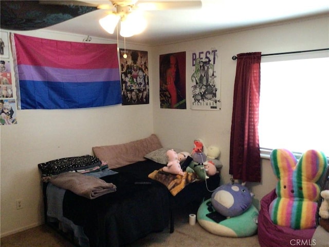 bedroom featuring ceiling fan, carpet, and multiple windows