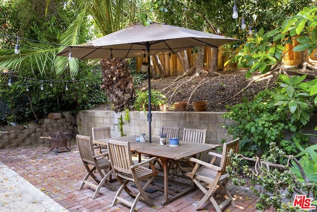 view of patio / terrace with an outdoor fire pit