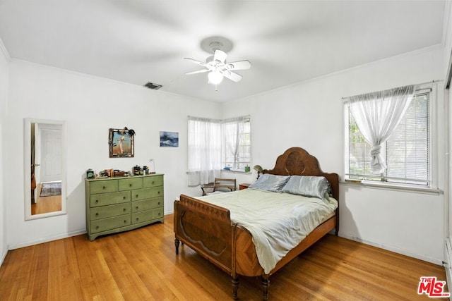 bedroom with multiple windows, ceiling fan, and light wood-type flooring