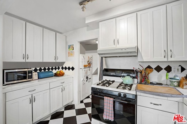 kitchen featuring white cabinetry, white appliances, and tasteful backsplash