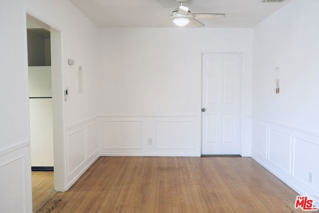 spare room with light hardwood / wood-style flooring and ceiling fan