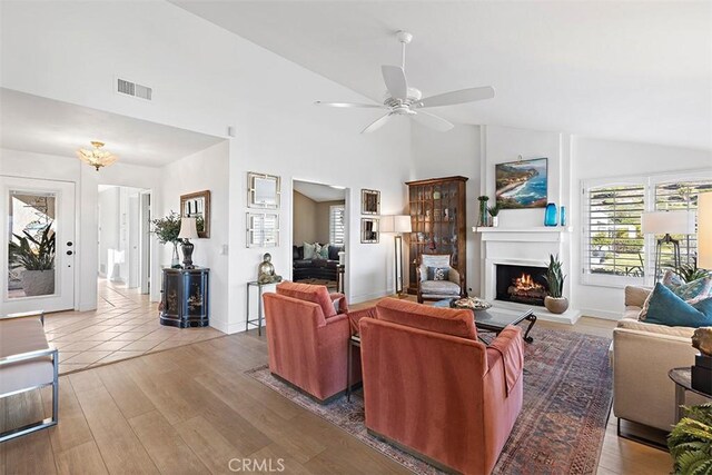 living room featuring ceiling fan, lofted ceiling, and hardwood / wood-style floors