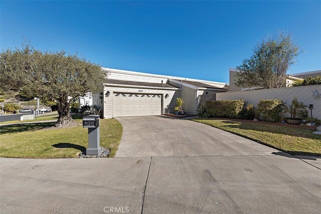 ranch-style house featuring a garage and a front yard