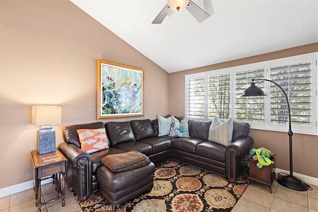 living room featuring light tile patterned floors, a wealth of natural light, and vaulted ceiling