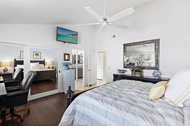 bedroom with high vaulted ceiling, connected bathroom, hardwood / wood-style floors, and ceiling fan