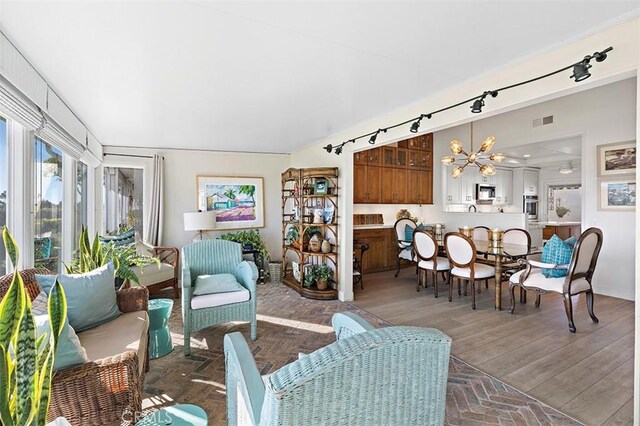 living room with wood-type flooring and a notable chandelier