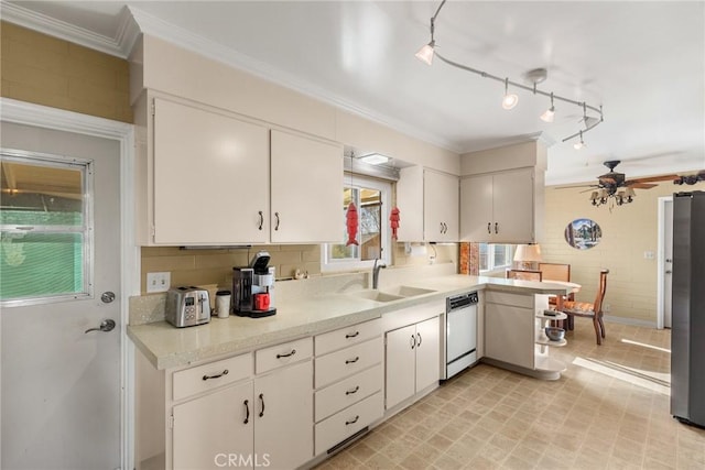 kitchen with white cabinets, stainless steel fridge, sink, and dishwashing machine