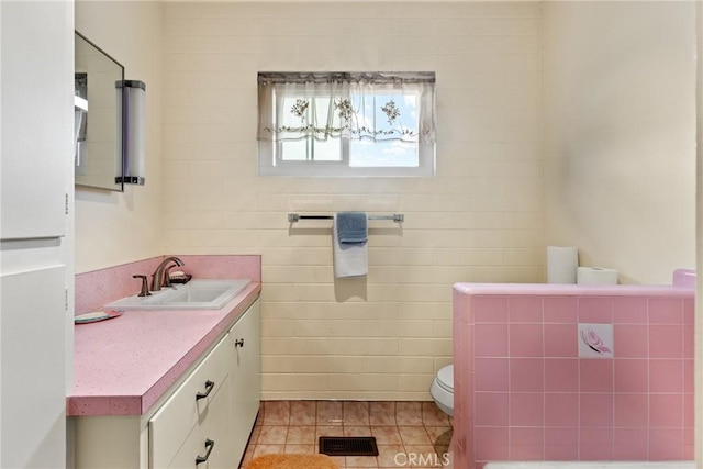 bathroom featuring tile patterned floors, vanity, and toilet