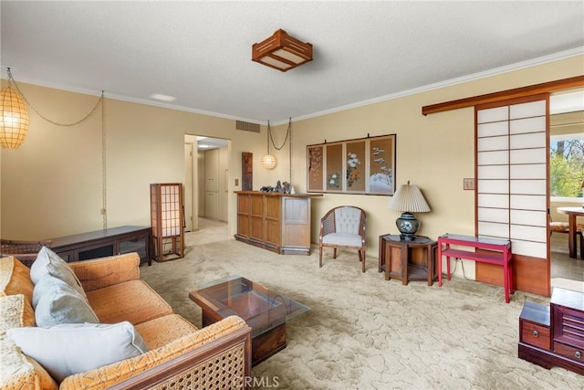 carpeted living room with ornamental molding and a textured ceiling