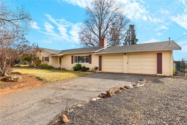 ranch-style home featuring a garage and a front yard