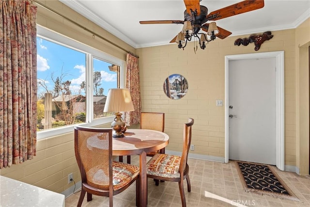 dining area with crown molding, brick wall, and a healthy amount of sunlight