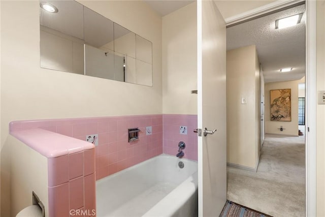 bathroom with a bath and a textured ceiling