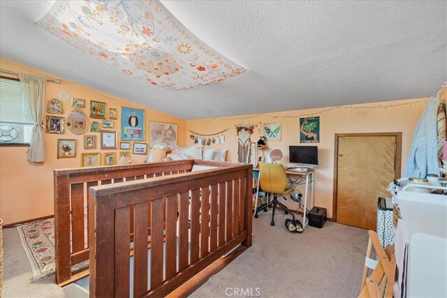 bedroom featuring lofted ceiling, light carpet, and a textured ceiling