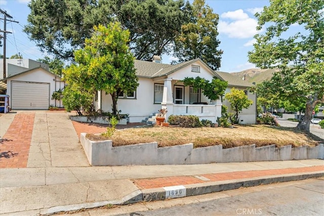 single story home featuring a garage and covered porch