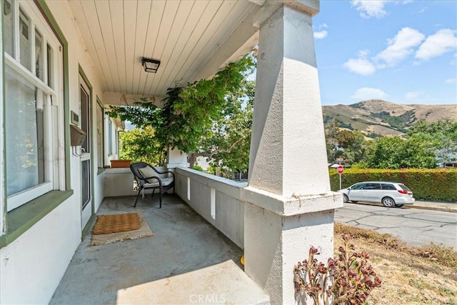 view of patio with a mountain view and covered porch