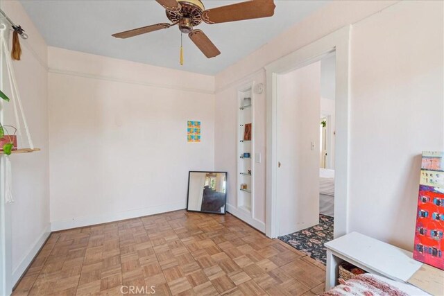 interior space featuring ceiling fan and light parquet floors