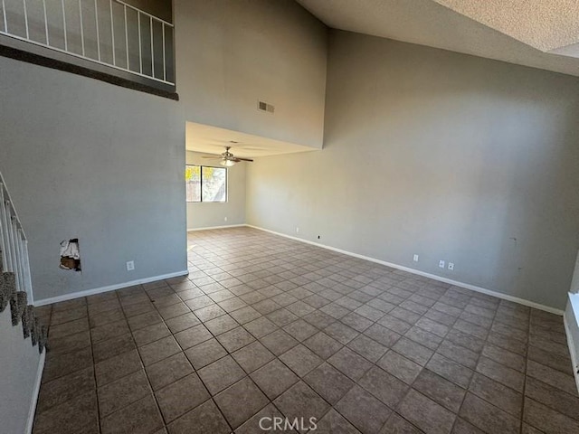 unfurnished living room with tile patterned flooring, high vaulted ceiling, a textured ceiling, and ceiling fan