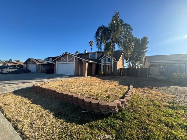 ranch-style home featuring a garage and a front lawn