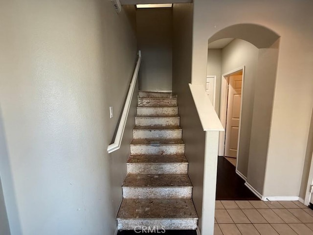 staircase featuring tile patterned floors