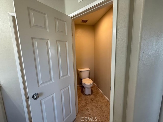 bathroom with tile patterned flooring and toilet