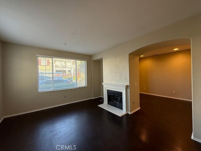 unfurnished living room featuring dark hardwood / wood-style flooring