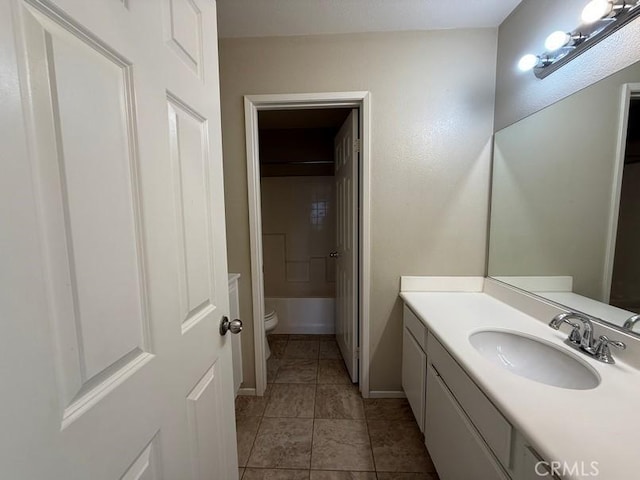 bathroom featuring vanity, tile patterned floors, and toilet