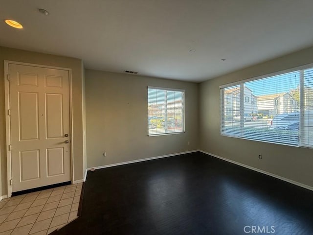 unfurnished room featuring light tile patterned floors