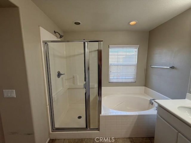 bathroom featuring tile patterned floors, vanity, and separate shower and tub