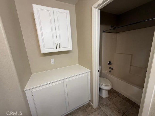 bathroom with tub / shower combination and toilet