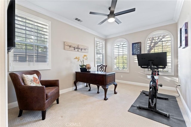 office space with ceiling fan, light colored carpet, and ornamental molding