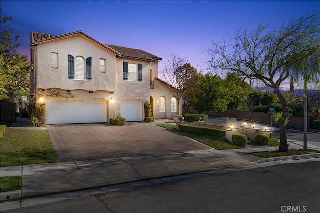 mediterranean / spanish home with a garage