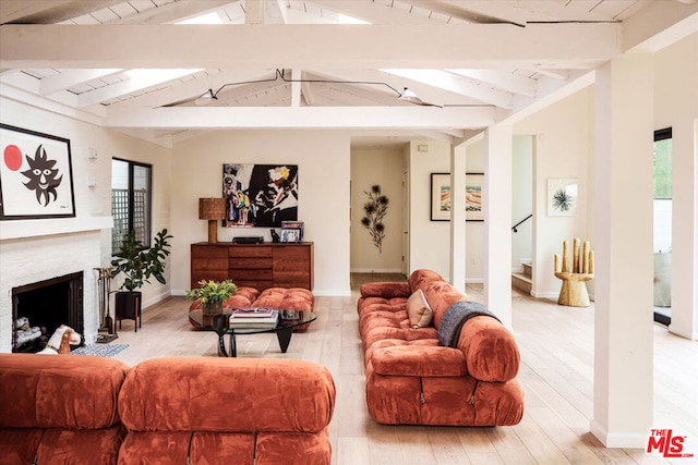 living room with wooden ceiling, light hardwood / wood-style flooring, and vaulted ceiling with beams