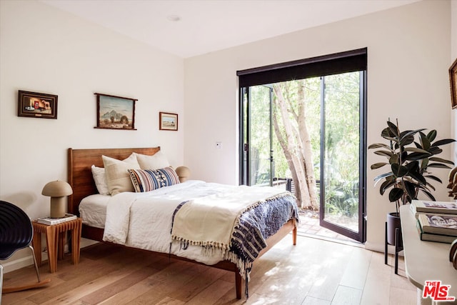 bedroom featuring access to exterior and light hardwood / wood-style flooring