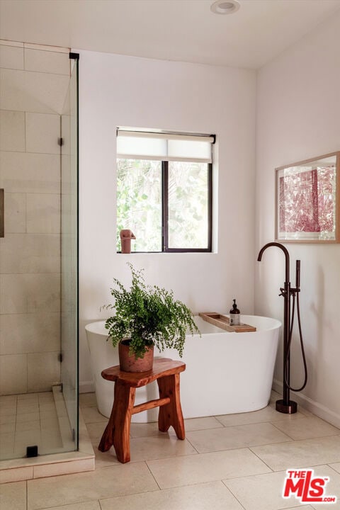 bathroom featuring tile patterned flooring and plus walk in shower