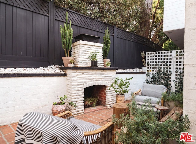 view of patio / terrace featuring an outdoor stone fireplace