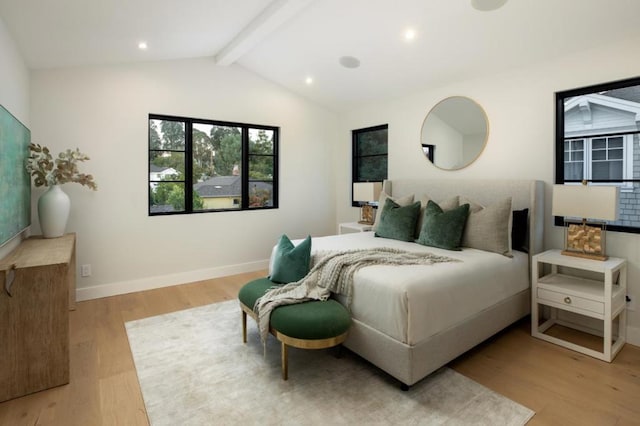 bedroom featuring lofted ceiling with beams and light hardwood / wood-style floors