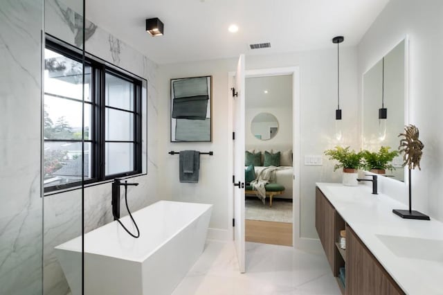 bathroom featuring a washtub and vanity