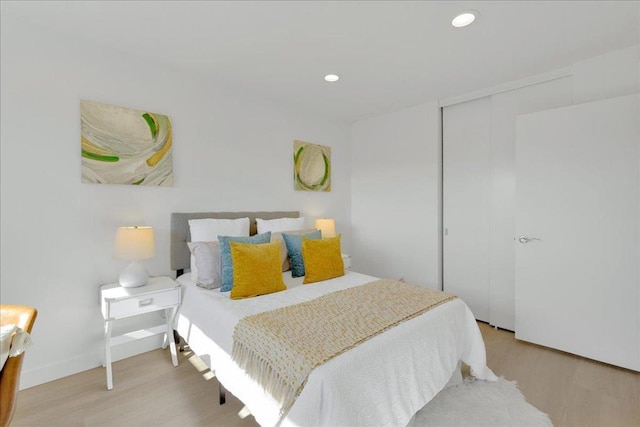 bedroom with a closet and light wood-type flooring