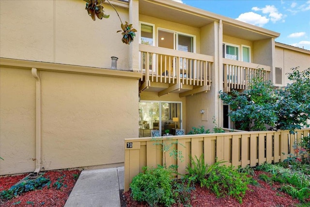 rear view of property featuring a balcony