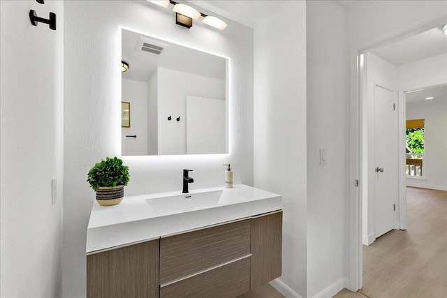 bathroom featuring vanity and hardwood / wood-style floors