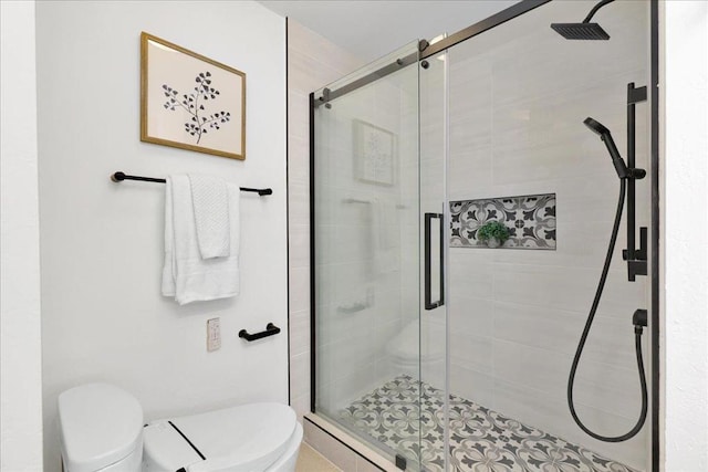 bathroom with an enclosed shower and toilet