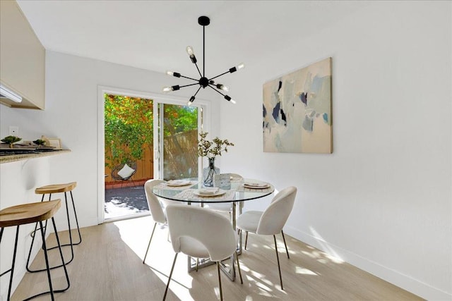 dining area with a chandelier and light hardwood / wood-style floors