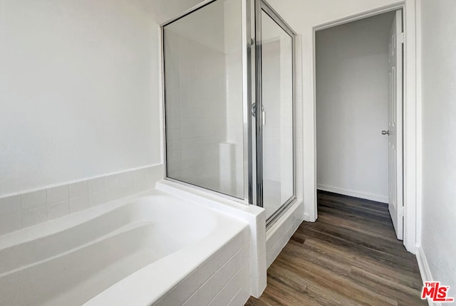 bathroom with separate shower and tub and hardwood / wood-style floors