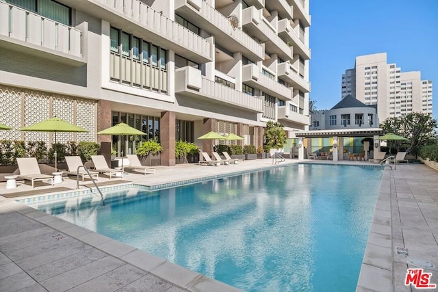 view of swimming pool featuring a patio area