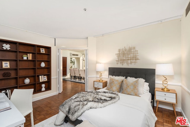 bedroom with dark parquet flooring