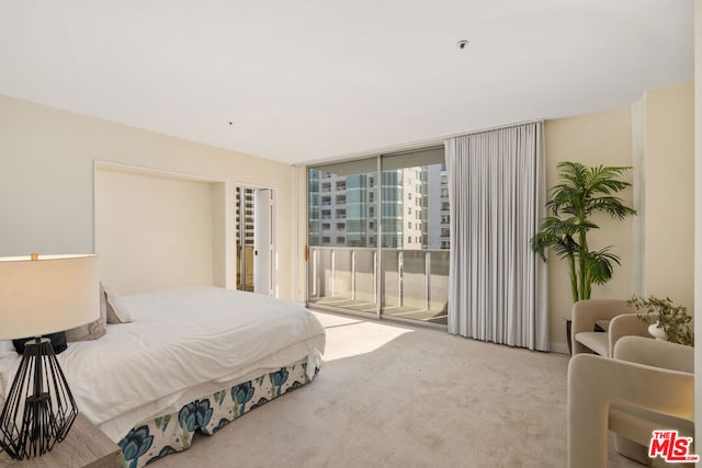 bedroom featuring access to exterior, carpet floors, and floor to ceiling windows